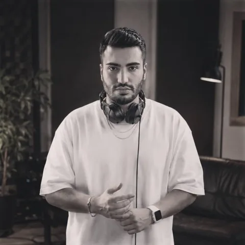Divo Move in a studio with headphones around his neck